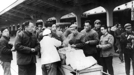 Los viajeros chinos compran su desayuno a un vendedor ambulante en la estación de trenes de Chunghow en 1975. El primer ministro Li Keqiang ha sugerido que más vendedores ambulantes podrían ayudar a solucionar una inminente crisis laboral.