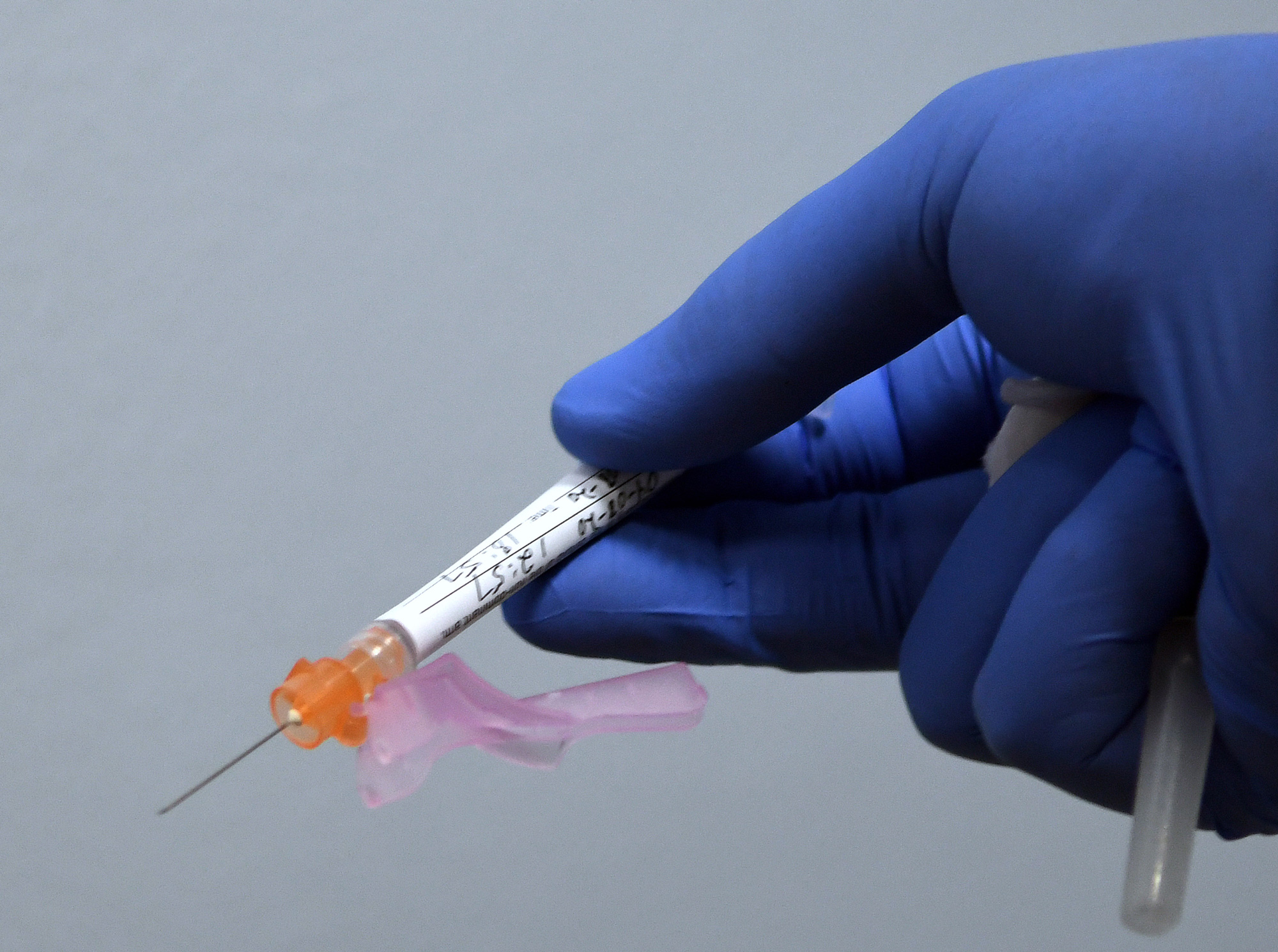 A syringe containing either a vaccine or a placebo is prepared for a participant in a Phase 3 COVID-19 vaccine clinical trial sponsored by Moderna at Accel Research Sites on August 4 in DeLand, Florida.