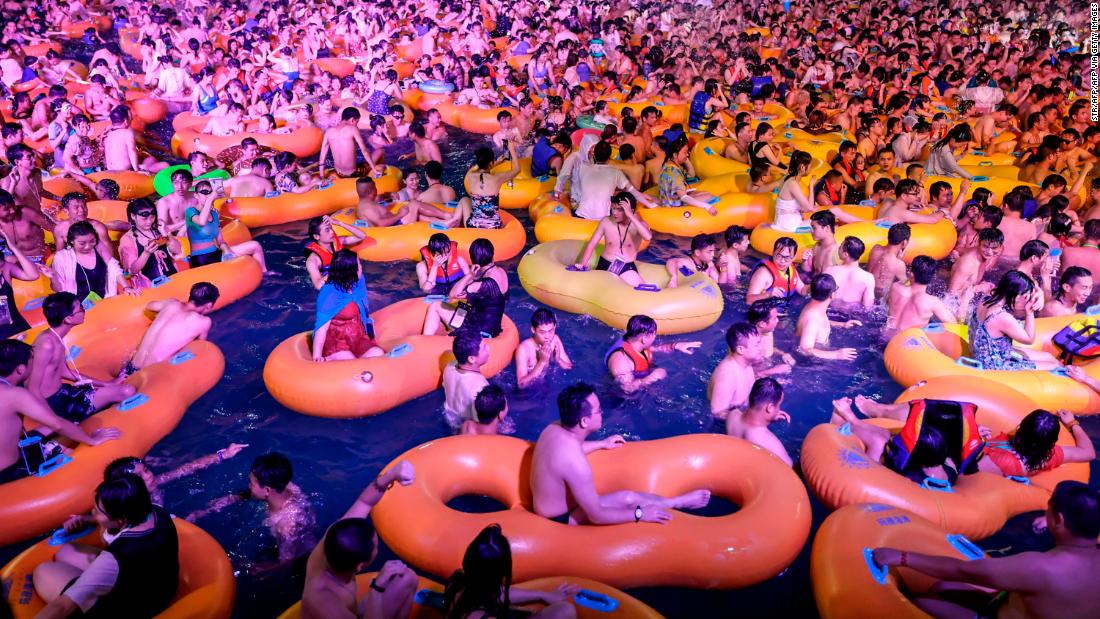 People watch a performance as they cool off at a water park in Wuhan, China on August 15.